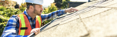 roofer inspecting shingles