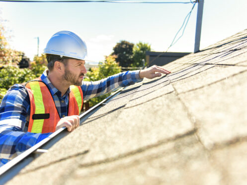 roofer inspecting shingles